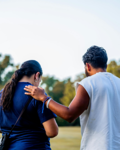 Exercise physiologist and young person walking outdoors together, representing exercise-based support during a mental health service transition